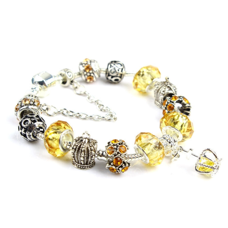 Silver-tone crystal bead bracelet with golden-yellow beads, ornate center charms, and chain extender