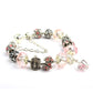 Pink glass bead bracelet with crown centerpiece, faceted light-pink crystals, dangling charm beads