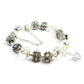 Silver-tone glass bead bracelet with filigree spacers, crown charm, and clear crystal drops