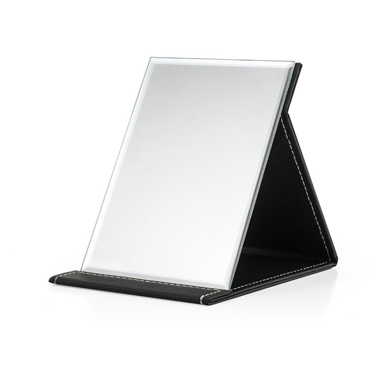 Folding desktop makeup mirror with white glass and black PU leather base, angled