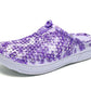 Women's slip-on clogs with purple floral printed fabric and white cushioned sole
