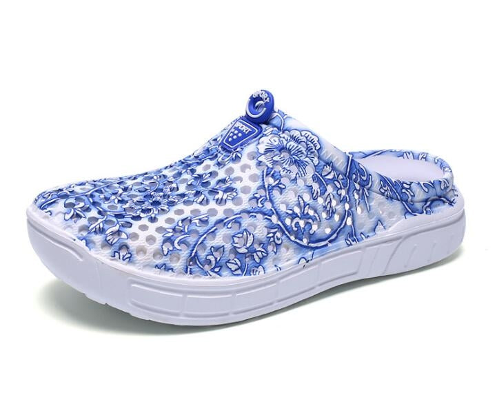 Women's slip-on clogs with blue floral fabric, angled side view, white cushioned sole