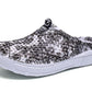Women's slip-on clogs with black-and-white floral fabric, side profile, white cushioned sole