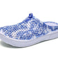 Women's slip-on clogs with blue floral fabric, angled profile, white cushioned sole