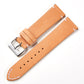 Tan leather watch strap with silver buckle and stitched edges, quick-release style