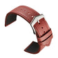 Red leather watch strap with silver clasp, perforation holes, and dark underside