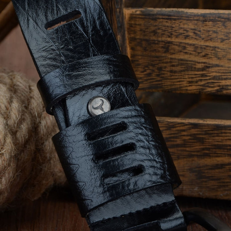 Close-up of dark leather pin buckle belt with embossed texture and metal keeper