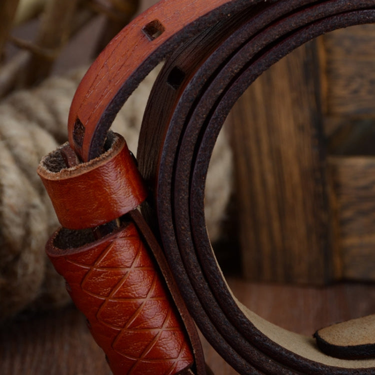 Close-up of red two-layer leather belt with stitched texture and dark pin-buckle side