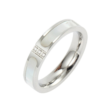 Silver-tone ring with three-diamond inlay, polished band, open oval center detail