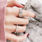 Two titanium steel diamond rings on a hand, one stacked band and one slim band.