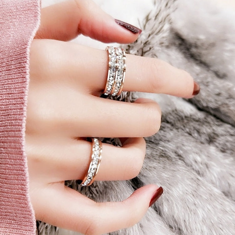 Two titanium steel diamond rings on a hand, one stacked band and one slim band.