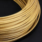 5mm braided cable tube, golden color, close-up of coiled braided strands