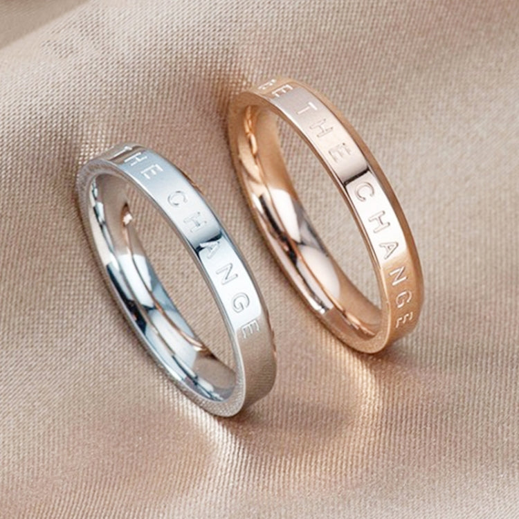 Two narrow rings side by side, rose gold and silver, engraved inner lettering
