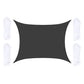Dark gray outdoor shade sail with corner grommets and white hanging ropes