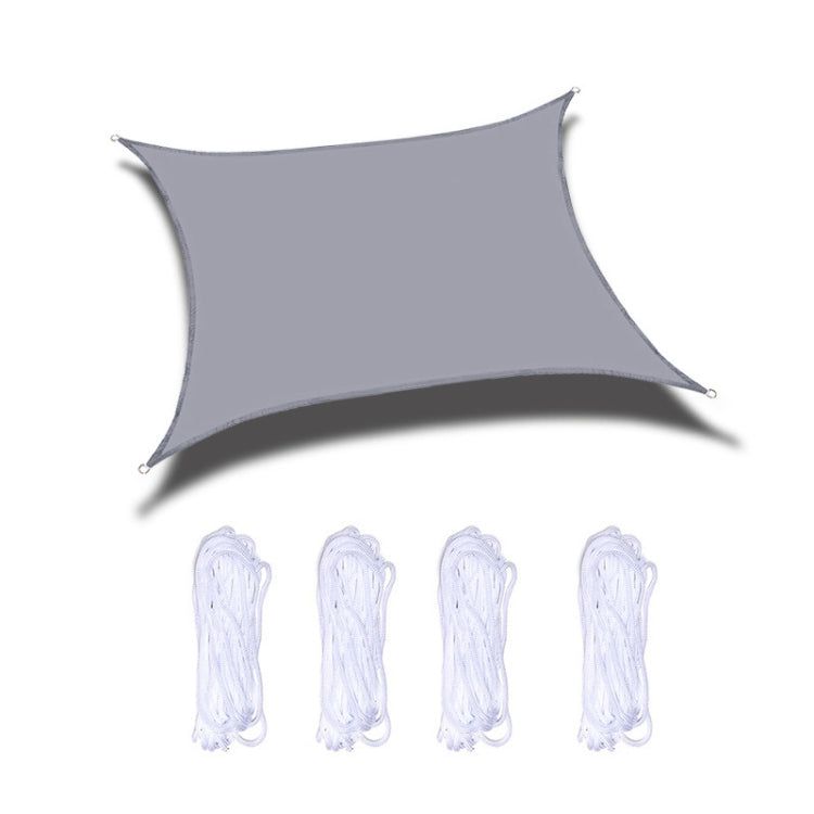 Light gray outdoor shade sail with corner grommets and white hanging ropes