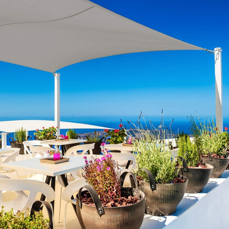 Waterproof sunshade sail canopy stretched over patio, secured with corner ropes