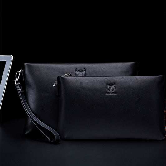Set of two black leather zip clutch bags with wrist straps, side-by-side view.