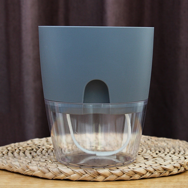 Gray transparent double-layer plastic flowerpot showing water reservoir through clear sides