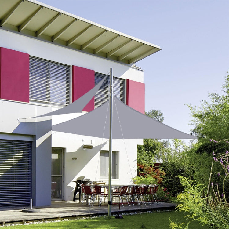 Outdoor garden sunshade sail canopy stretched over a patio with metal poles