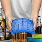 Blue silicone ice cube tray held above glasses, showing 24 square cavities