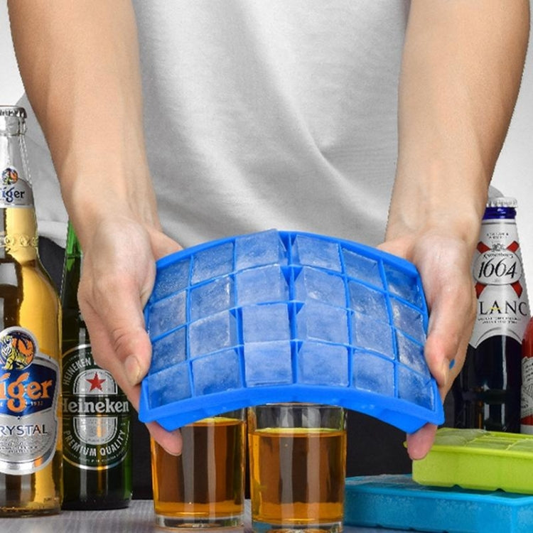Blue silicone ice cube tray held above glasses, showing 24 square cavities