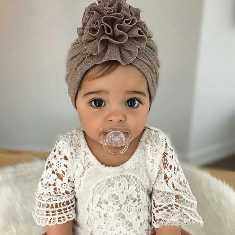Gray baby turban hat with ruched flower top, worn on baby