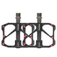 Black carbon fiber platform bike pedals with red screws, dual threaded axles.