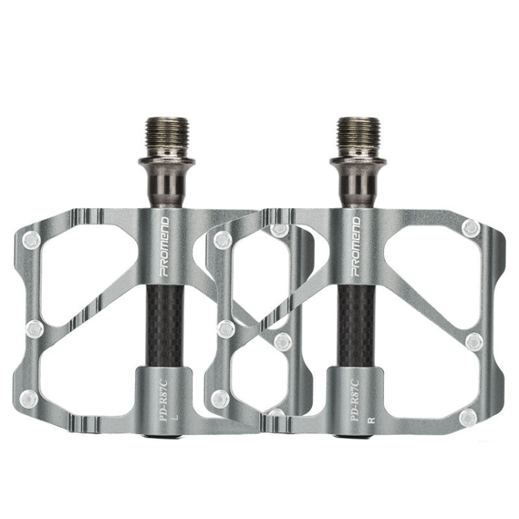 Silver carbon fiber bicycle platform pedals, dual studs and threaded axles.