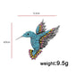 Blue rhinestone bird brooch with colorful accents, layered wings, and metal pin back