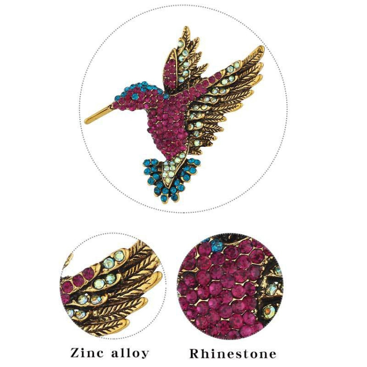 Purple and gold rhinestone bird brooch with teal accents and metal pin back