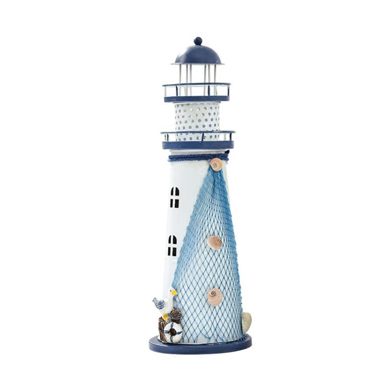 Standing blue and white lighthouse ornament with mesh tower, lantern cages, and seaside details