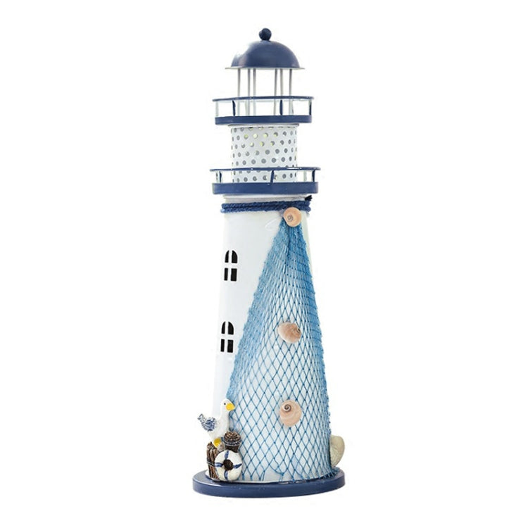 Blue and white tin lighthouse decoration with mesh body, stacked lantern rings, and base ornaments