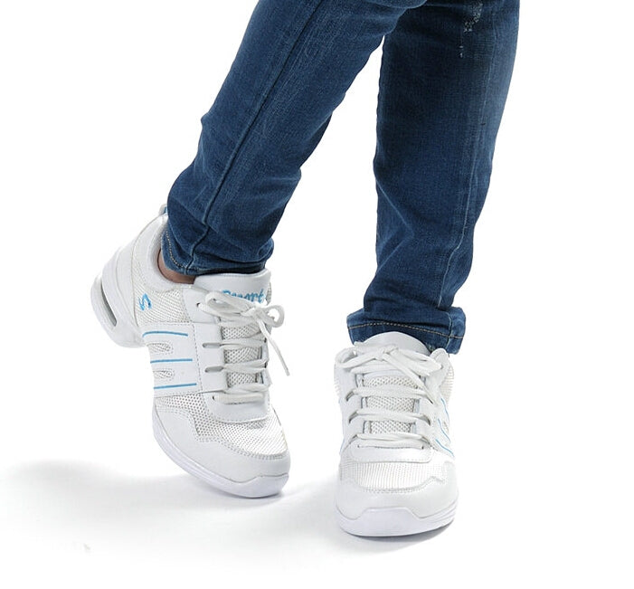 White lace-up breathable dance sneakers on feet with cushioned sole