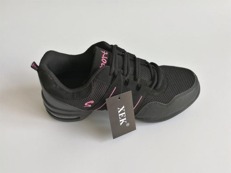 Black lace-up dance shoes with pink accents and hanging tag