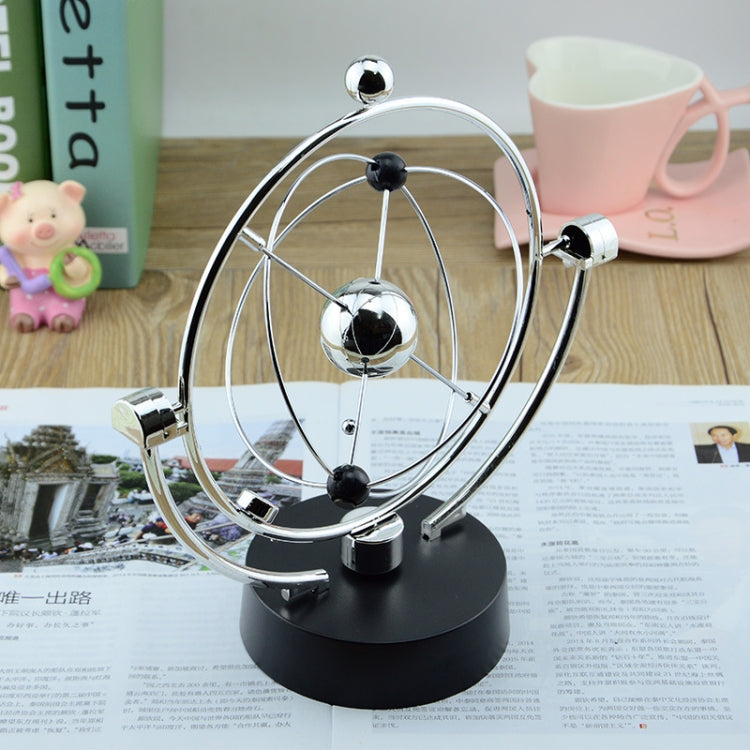 Rotating magnetic globe ornament with chrome ring, reflective silver globe, and black base
