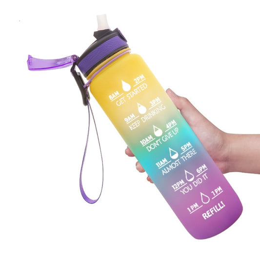 Gradient Tritan sports water bottle with purple lid and carry strap, held in hand