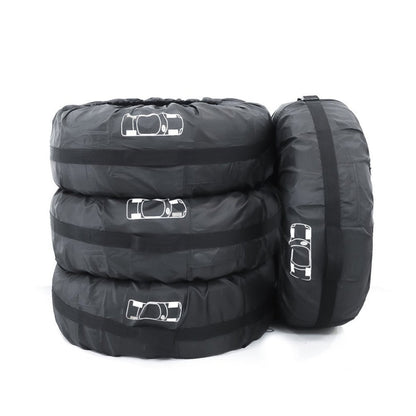 Black padded spare tire cover with multiple car-outline panels and strap loops