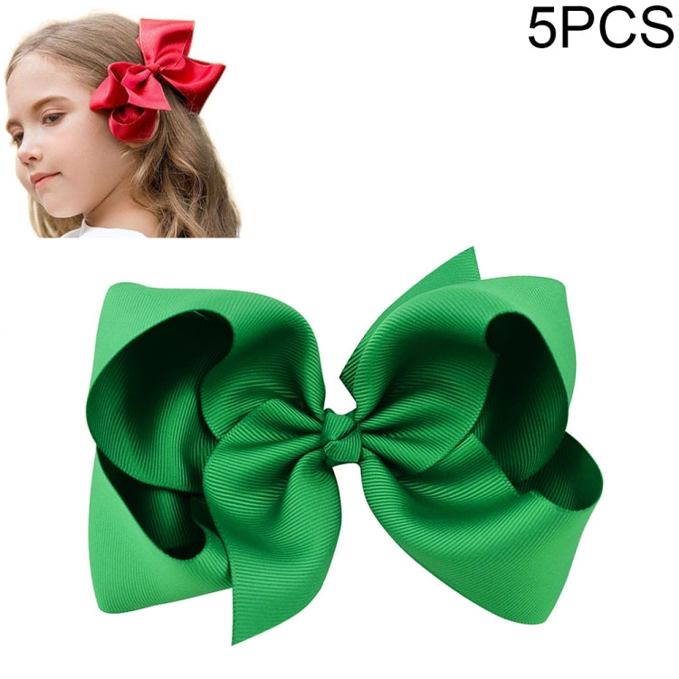 Green layered ribbon bow clip, large double-loop; red bow shown on child.