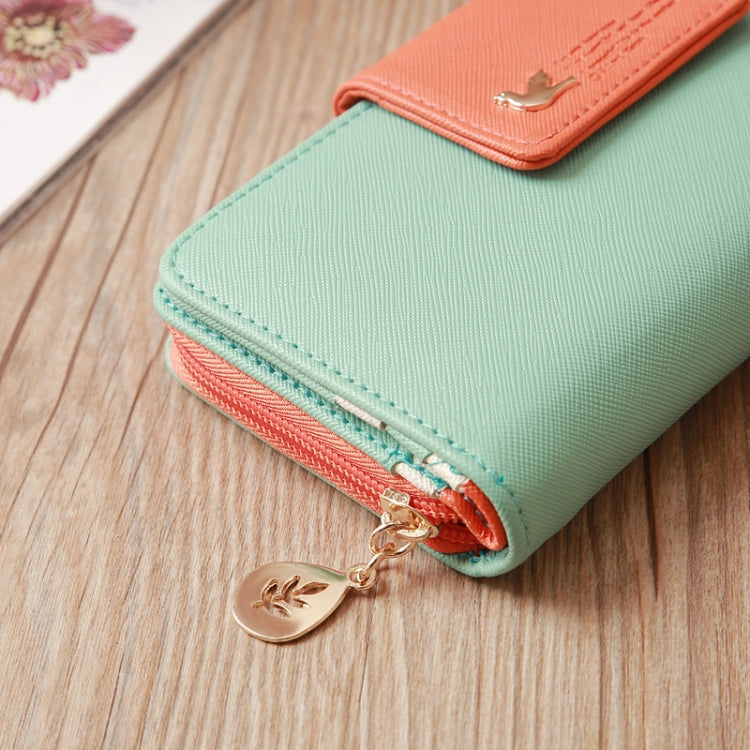Two-tone long zipper wallet with mint green body, orange accent, and front card pocket.