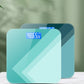 Teal digital body scale with blue LCD reading centered on the glass surface