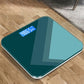Teal smart scale with blue digital LCD weight display and glossy glass top