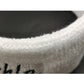 White knit sweatband close-up, textured terry-like fabric edge