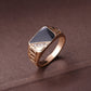 Gold-tone men's enamel ring with black center and rhinestone trim, geometric band