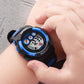Children digital sport watch on wrist, black and blue case, glowing LCD time display