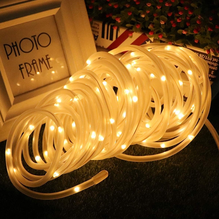 Warm white LED tube string lights with glowing clear tubes, coiled loop view