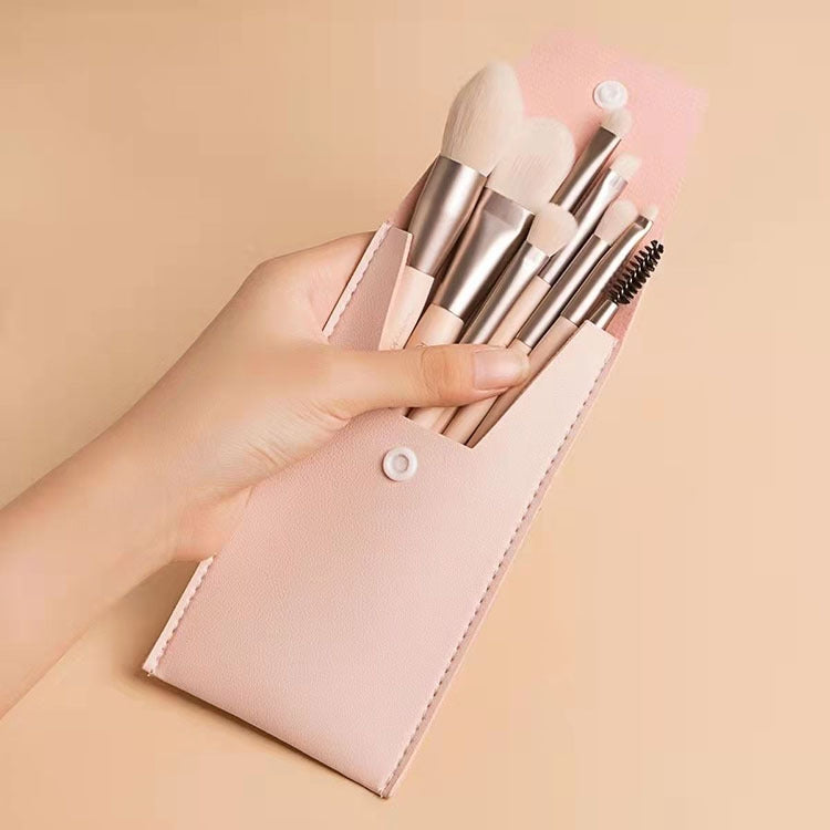 Pink mini makeup brush set with 8 brushes in a snap-closure holder