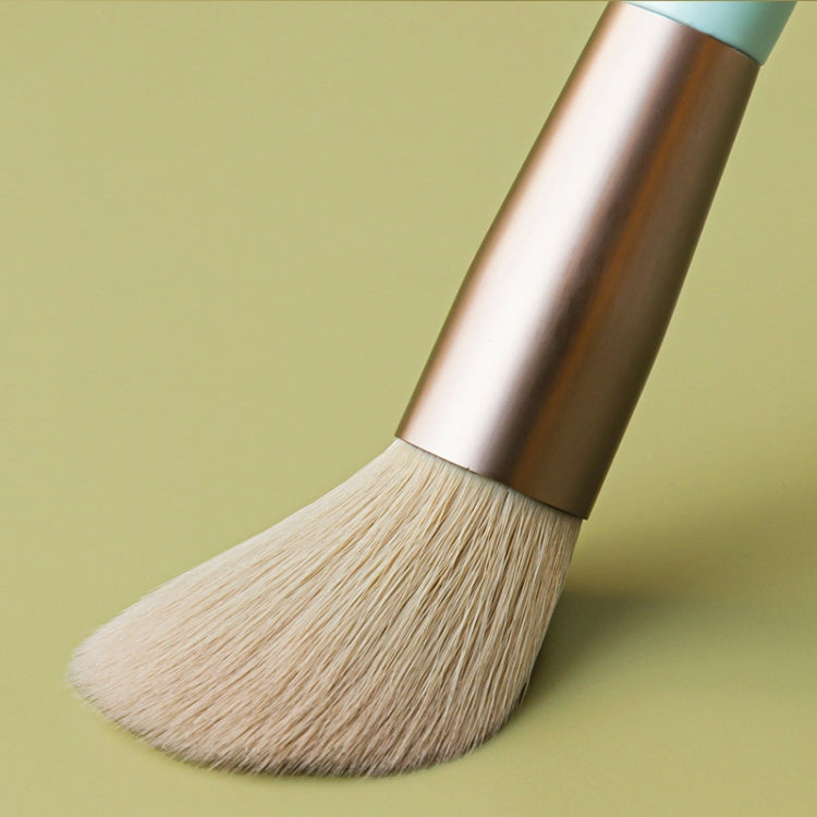 Loose powder brush with beige bristles and metallic rose-gold handle