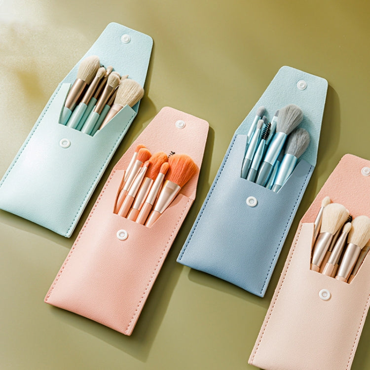Four mini makeup brush sets in pastel colors with snap-closure holders