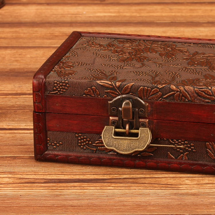 Vintage wooden jewelry box close-up of engraved lid and brass lock handle