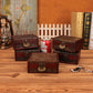 Vintage wooden jewelry box with red engraving, plus other matching boxes on tabletop